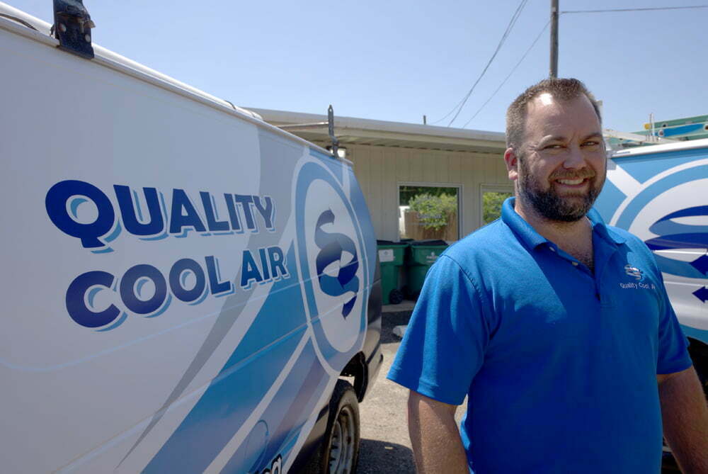quality cool air team member next to work truck